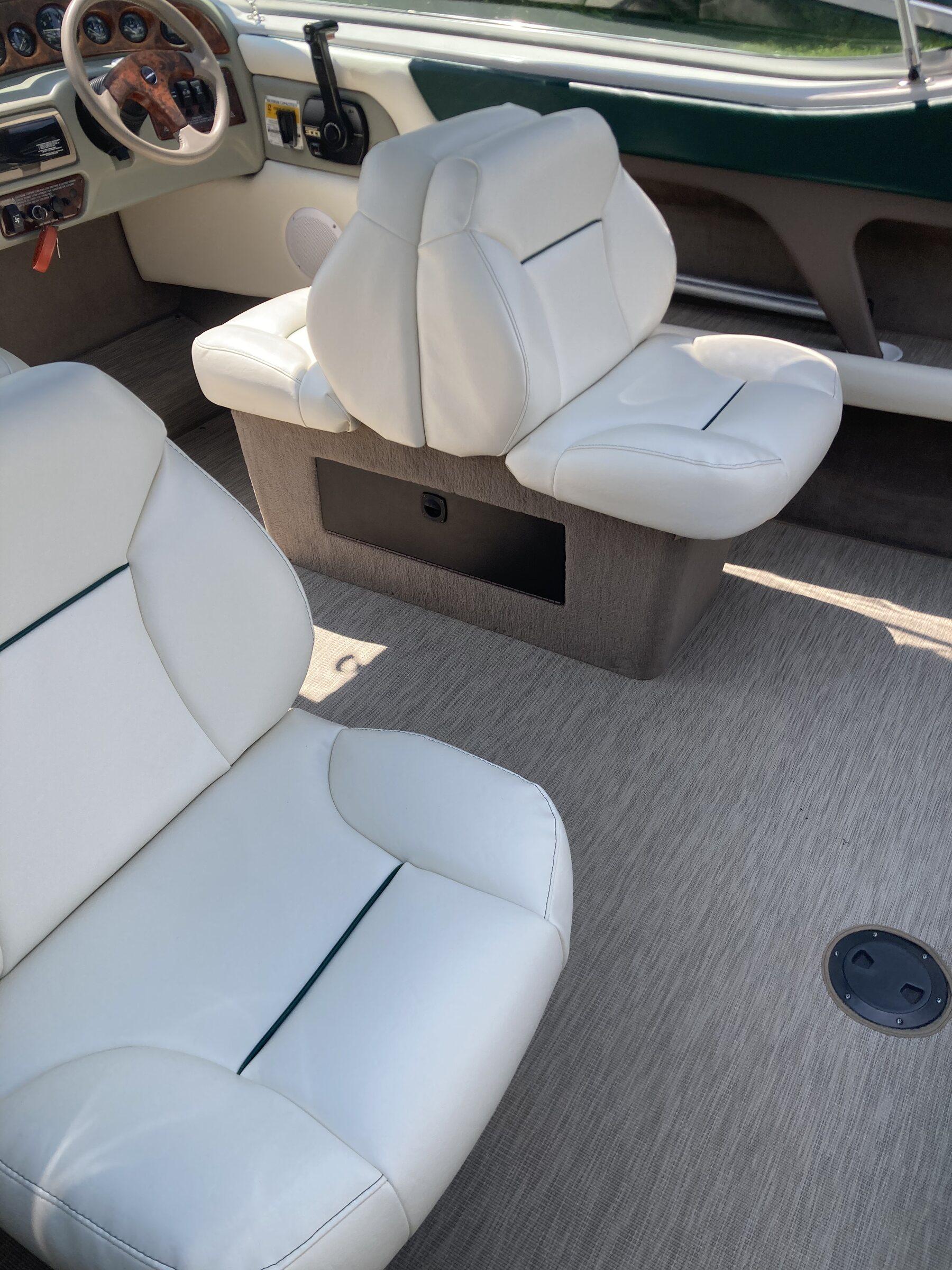 Finished marine interior with white upholstery and dark gray and green accents
