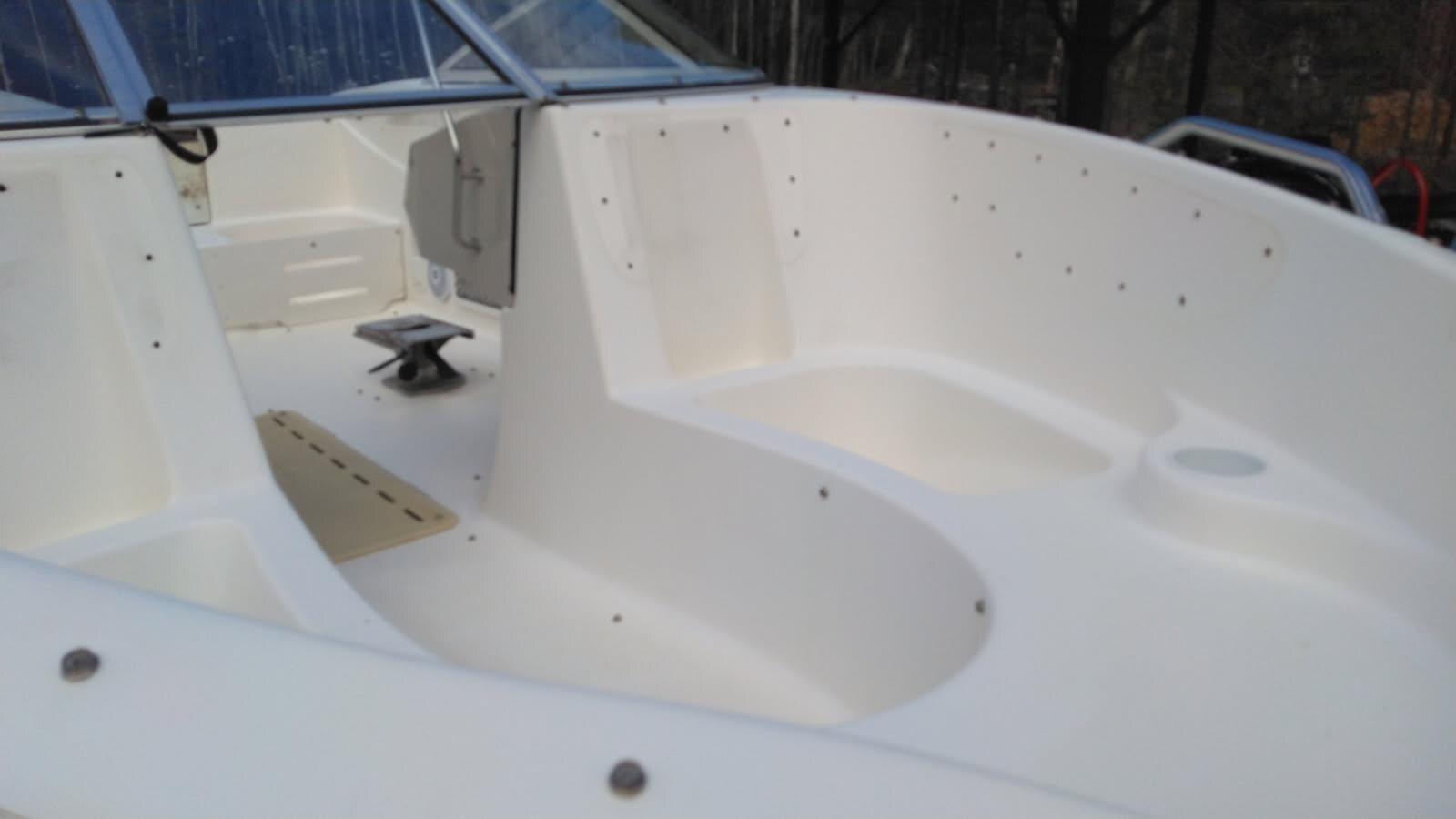 Close view of a cleaned white fiberglass cockpit surface after restoration
