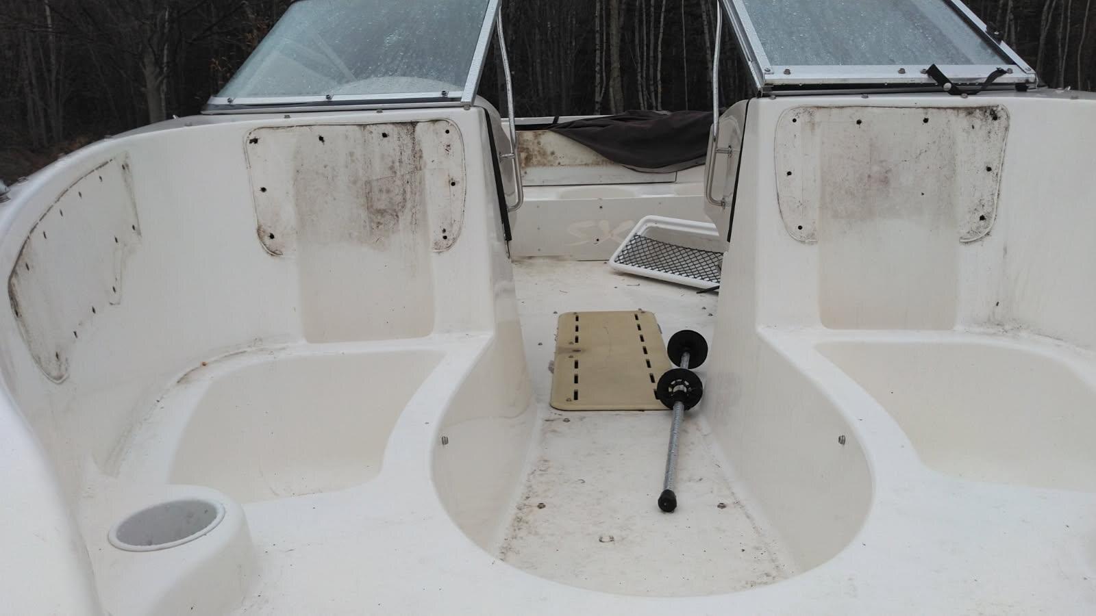 White fiberglass boat cockpit with dirt and mildew before cleaning
