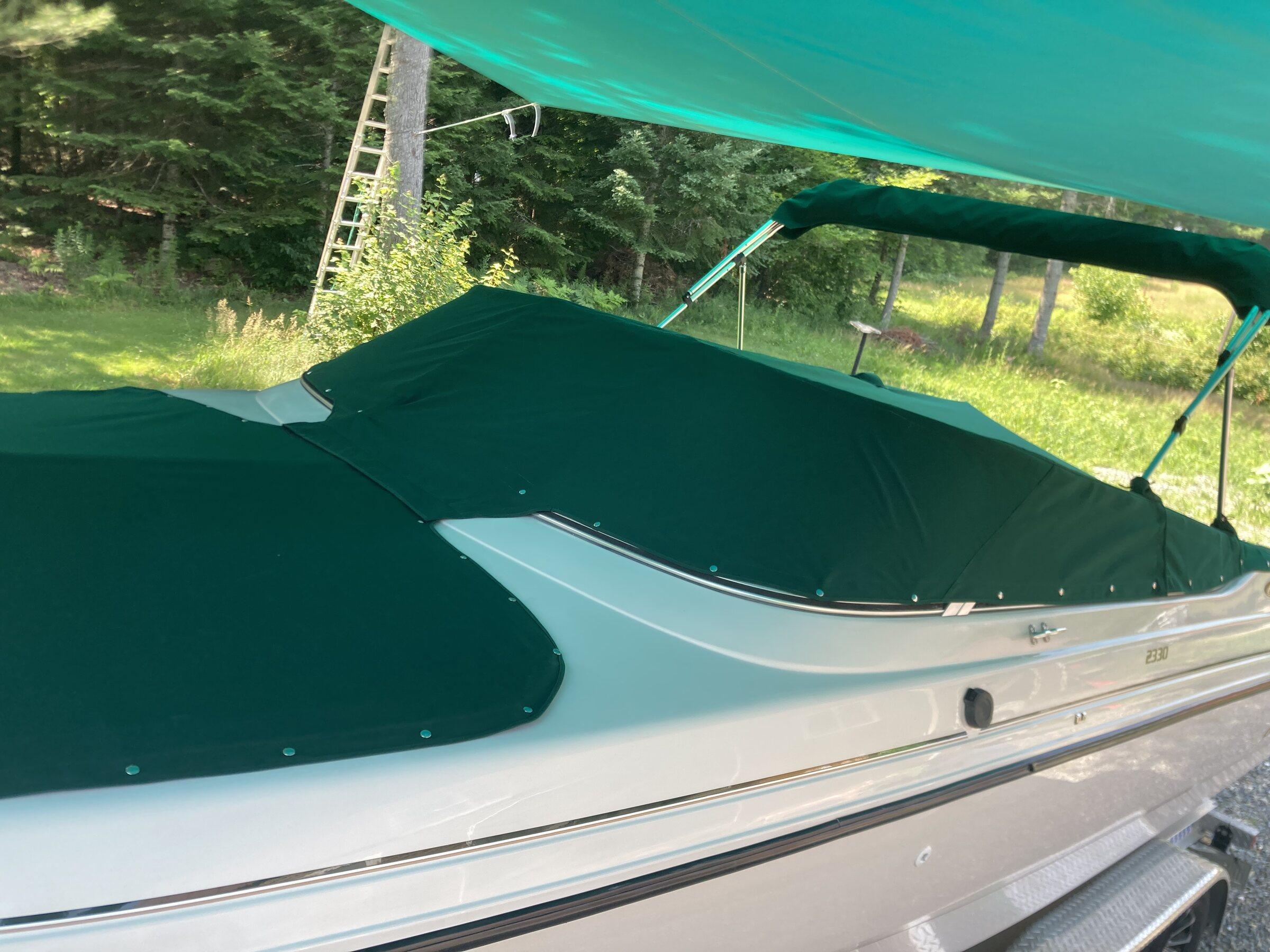 Custom green fitted boat cover viewed from the side