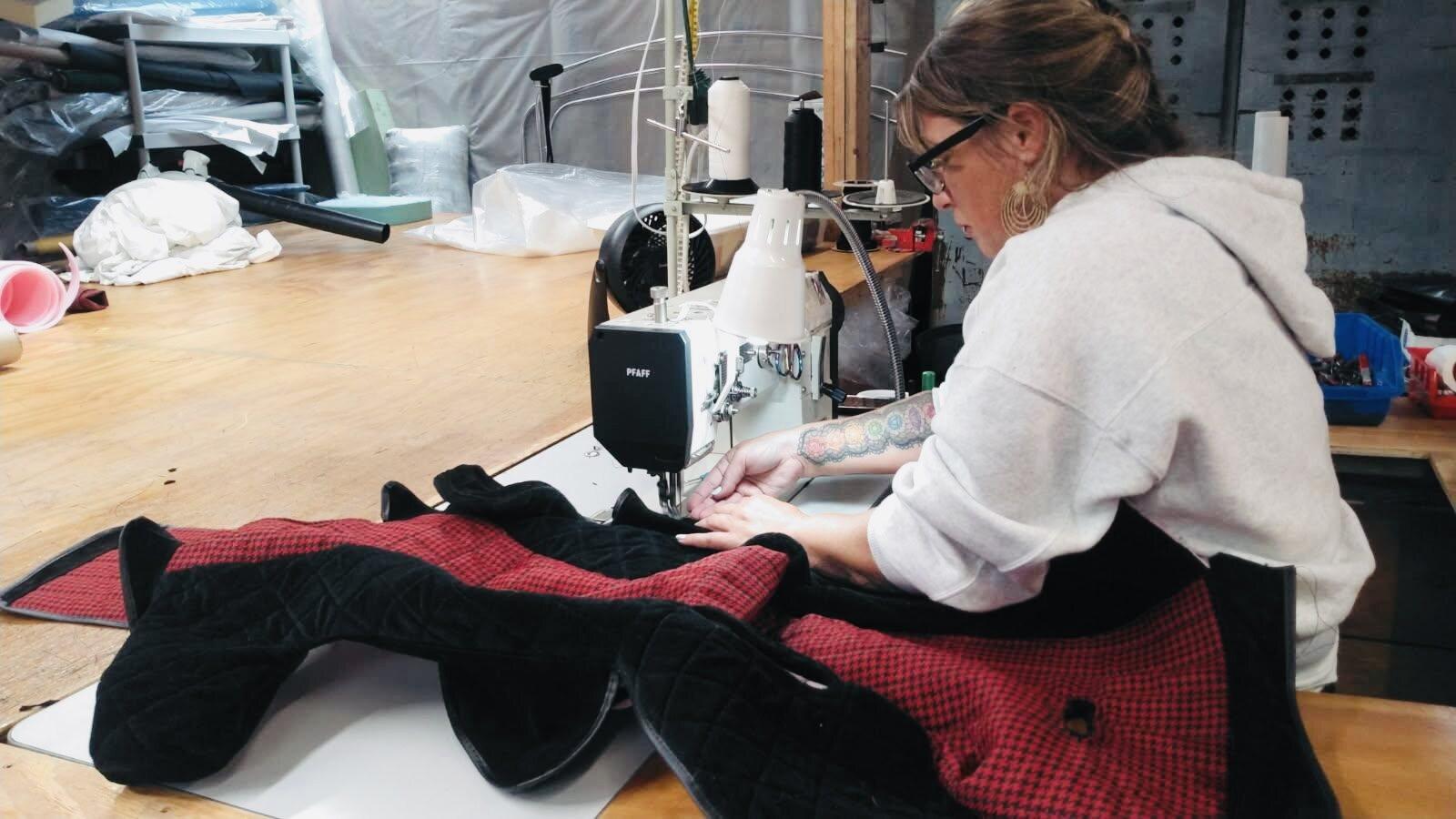 Custom racecar seat cover being stitched at the sewing machine
