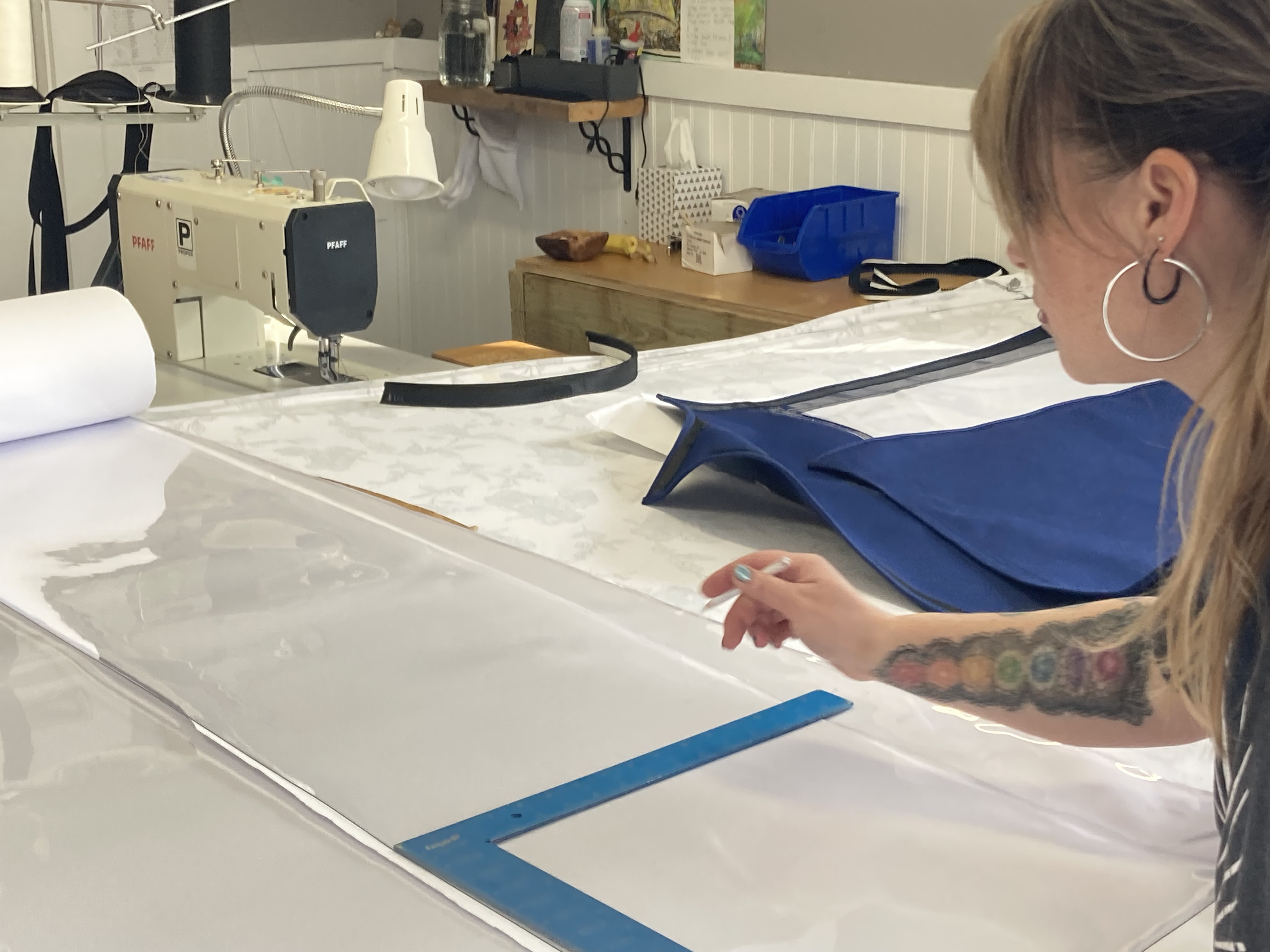 Camilla working at the cutting table in the We've Got You Covered shop