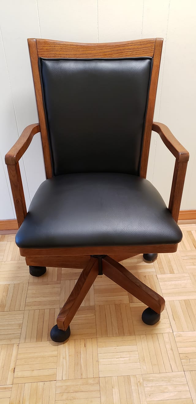 Custom reupholstered office chair with black leather and oak frame